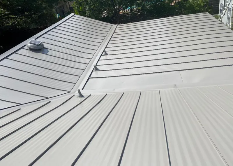 Solar attic fan installed on a metal roof for Roof Ventilation in Wesley Chapel