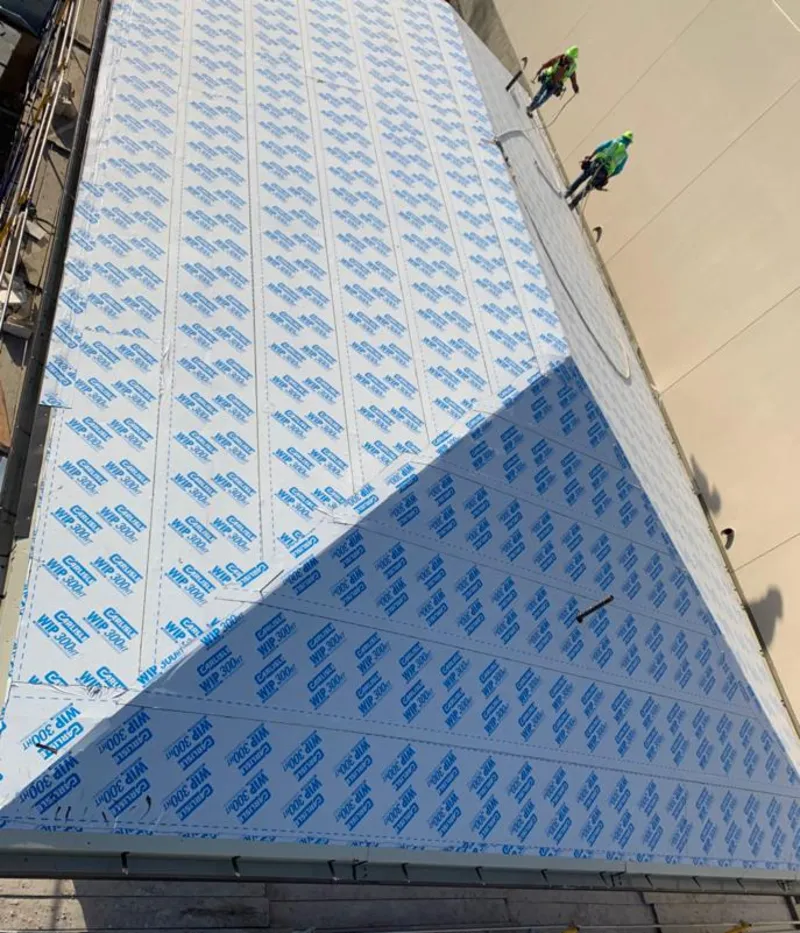 Professional roofers installing underlayment on a metal roof in Wesley Chapel